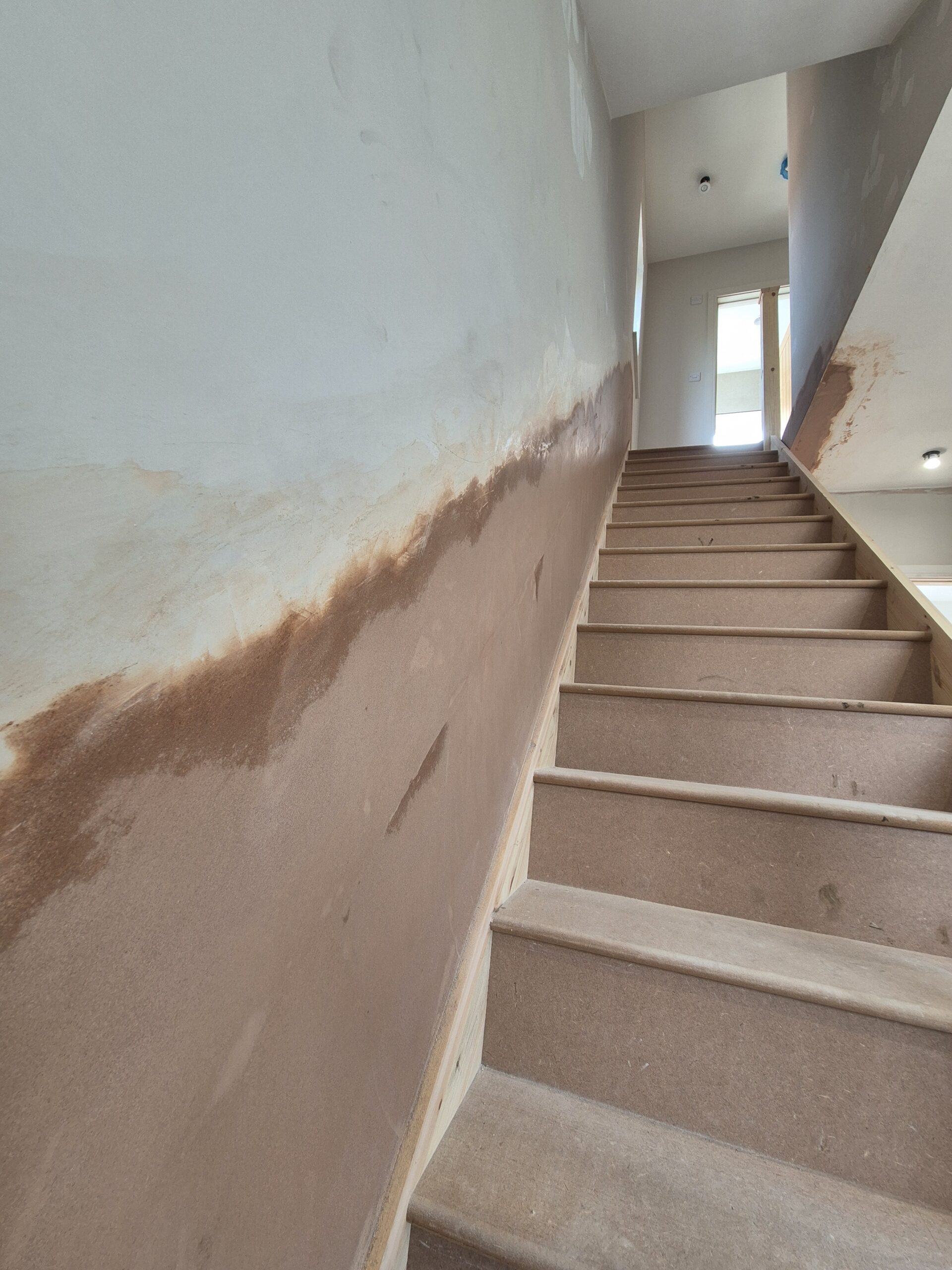 Stairwell walls during a full plastering project